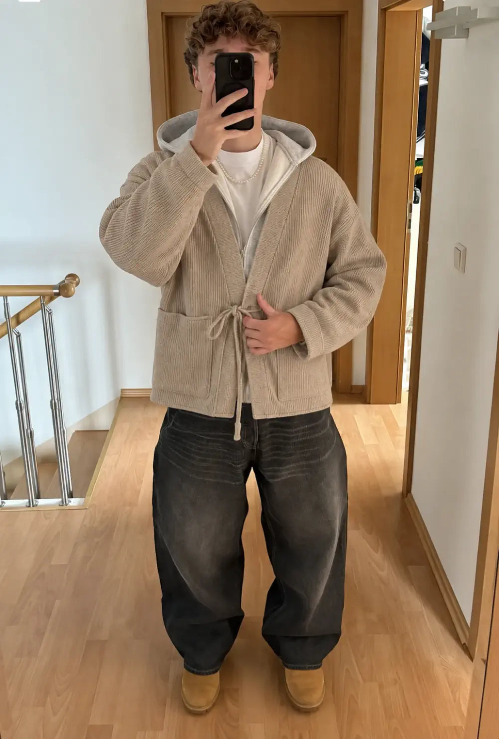 Veste kimono homme beige style cardigan portée nouée sur un sweat à capuche et un jean noir large